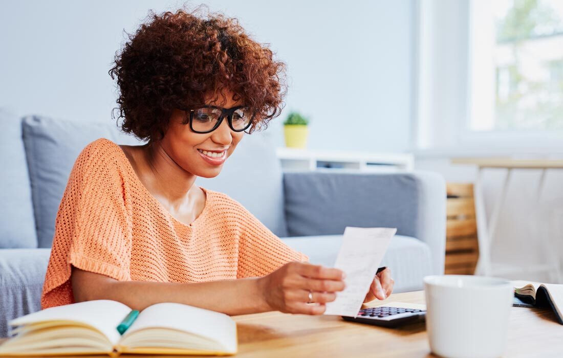 woman utilizing financial wisdom to calculate expenses